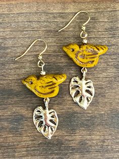 Czech Glass Rustic Bird Earrings with Gold Color Leaf accents and Mustard Brown tones create a beautiful, vintage style jewelry piece. These earrings feature stainless steel hooks for durability and elegance. 𝗗𝗘𝗧𝗔𝗜𝗟𝗦 ✨ Materials:  Czech glass birds, gold colored leaves, gold filled spacers, gold hypoallergenic stainless steel hooks ✨Size:  Approximately almost 2 inches long, birds are about 22 mm (see picture for more detailed measurement) ✨ Colors: Gold, brown-mustard ✨ Colors may appear Unique Yellow Pierced Earrings, Unique Yellow Earrings, Vintage Yellow Dangle Earrings, Vintage Yellow Dangle Jewelry, Yellow Brass Jewelry With Matching Earrings, Handmade Vintage Yellow Earrings, Vintage Handmade Yellow Earrings, Vintage Yellow Nickel-free Earrings, Handmade Yellow Brass Earrings