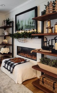 a living room decorated for christmas with candles and decorations on the fireplace mantels