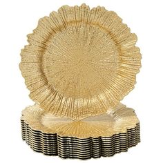 a gold plate sitting on top of a stack of black and white striped paper plates