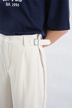 Make a statement with these Wide Leg Pleated Trousers, featuring a modern buckle detail for an elevated touch. Constructed with a focus on quality craftsmanship, these trousers boast a structured pleated design and are cut from a soft yet durable fabric blend. The relaxed silhouette is accentuated with clean lines, providing both style and comfort for day-to-night ensembles. Easily adaptable, they can be styled with a fitted turtleneck for professional settings or paired with a casual tee for an Formal Pants With Belt For Spring, Elegant Tapered Leg Bottoms With Belt Detail, Spring Formal Pants With Belt, Workwear Bottoms With Belt And Tapered Leg, Workwear Bottoms With Removable Belt, Tapered Leg Workwear Bottoms With Belt, Elegant Trousers With Belt Detail, Fitted Bottoms With Removable Belt For Work, Modern Trousers With Belt Loops