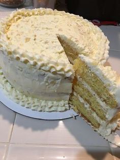 a large white cake with one slice cut out