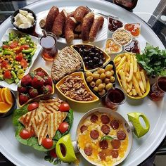 a white plate topped with lots of different foods and condiments on top of it