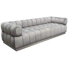 a large gray couch sitting on top of a white floor