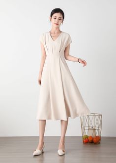 "Cool and comfortable for hot summer days, this beige dress is elegant and stylish.    It is a wonderful wardrobe staple that's a timeless classic you'll wear again and again. All our items are Tailored and Handmade and Made to Order ,I can make Any Size . I design new styles every week, please collect my store. I believe that you will meet your favorite styles. ★★FEATURES Polyester fabric Two side pockets Back zipper closure V neck Short sleeve Midi dress Casual dress Beige dress Simple dress P Elegant Solid Color V-neck Dress For Spring, Casual Neutral V-neck Maxi Dress, Beige V-neck Dress For Summer, Cream A-line Maxi Dress For Summer, Feminine Beige V-neck Maxi Dress, Neutral V-neck Spring Dress, Elegant Beige V-neck Short Sleeve Dress, Elegant V-neck Evening Dress For Summer, Feminine Midi Dress With Notched Neckline For Summer