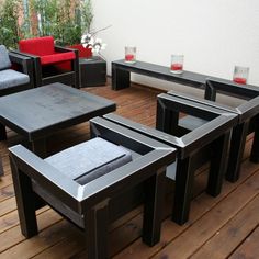 an outdoor seating area on a deck with chairs and tables in the center, surrounded by potted plants