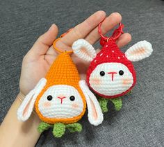 two small crocheted animals are being held in someone's hand