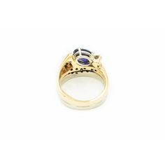 Very cool modernist stylized ring featuring a prong set oval tanzanite  (approximately 1.65 carats) which is accented by a single .15 carat (approximate weight) carat round full cut diamond and an additional 19 bead set diamonds.  The approximate total diamond weight for the piece is .50 carats.  The shank is yellow and white 14k gold.  there looks like there were hallmarks, but they have faded. Ring is is 7.25 US . Modern Oval Tanzanite Sapphire Ring, Modern Tanzanite Gemstone Ring, Modern Tanzanite Rings, Modern Sapphire Ring Oval Cabochon For Formal Occasions, Oval Tanzanite Ring For Formal Occasions, Formal Oval Tanzanite Ring, Oval Tanzanite Ring With Brilliant Cut, Oval Tanzanite Birthstone Ring With Accent Stones, Oval Tanzanite Rings Fine Jewelry