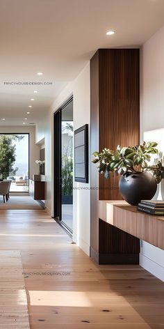 a long hallway with wooden flooring and white walls, leading to an open living room