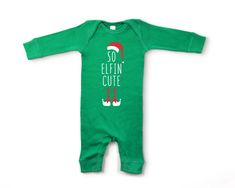 An adorable and cozy baby outfit for the Christmas season! These baby rib coveralls are just so elfin' cute! Made from buttery-soft, quality airlume cotton that provides all day comfort, breathability and flexibility for all activity levels. 100% combed ring-spun cotton Soft, lightweight & breathable material Baby rib cuffs on sleeves and leg opening Double-needle ribbed binding on neck & shoulders Flatlock seams Reinforced snap closure CPSIA compliant; Easytear™ label Care instructions: Newborn Christmas Gifts, Christmas Baby Announcement, Holiday Baby Shower, Baby Christmas Outfit, Green Baby, Baby Outfit, Graphic Tops, Neutral Baby