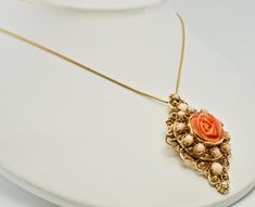 "Pink Brooch, Pink Pendant, Angel Skin Coral Brooch, Pink Coral Pendant, & Red Coral, Sea Coral, Cultured Pearls, Rose Pendant, Rose Brooch, Floral Pendant, Floral Brooch, Convertible Brooch/ Pendant, 14K Gold. This gorgeous vintage Brooch is finely crafted in solid 14K Yellow gold (stamped and also carefully tested and guaranteed). The center beautiful carved coral flower measures 16mm. It is complimented with ten Angel skin pearls of 3mm and two corals of 4mm. Two 2mm each cultured pearls Elegant Rose Design Brooches For Anniversary, Rose Colored Wedding Brooch Jewelry, Gold Flower Pendant Brooch Jewelry, Vintage Rose Brooch Jewelry, Vintage Rose Jewelry With Brooch, Elegant Red Coral Pendant Jewelry, Vintage Rose Brooch, Coral Rose Necklace, Vintage Coral Oval Jewelry