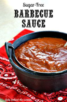 a bowl of barbecue sauce sitting on top of a red towel