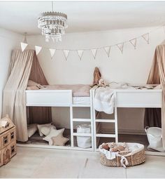 a bedroom with bunk beds and curtains on the ceiling, lights hanging from the ceiling