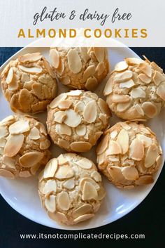 a white plate topped with cookies covered in almonds