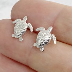 Cute tropical earrings! Sterling silver sea turtle earrings, perfect for summertime - all the time. These are cast in our studio, then tumbled and polished to a high shine. We do ship these in a white gift box, so they are perfect for giving! Think about the new grad, going away gift, or a birthday gift for the turtle collector. D E T A I L S • Sterling Silver • Length: 12mm • Lightweight and perfect for everyday wear. *These silver sea turtle earrings are a made to order item - ships within 3-5 Nickel-free Ocean-inspired Earrings For Gift, Nickel-free Silver Ocean-inspired Earrings, Ocean-inspired Hypoallergenic Jewelry As A Gift, Ocean-inspired Hypoallergenic Jewelry Gift, Ocean-inspired Silver Jewelry With Matching Earrings, Silver Ocean-inspired Earrings For Gifts, Nickel-free Silver Turtle Jewelry, Sea Turtle Jewelry, Tropical Earrings