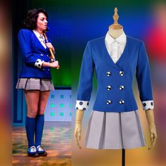 a woman standing next to a mannequin wearing a blue jacket and skirt