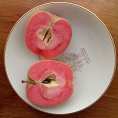 two pieces of apple sitting on top of a white plate