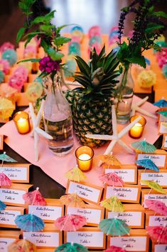 pineapples, candles and place cards on a table