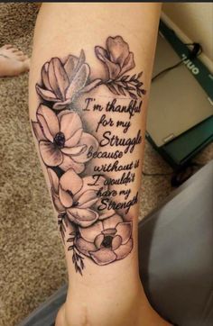 a woman's leg with flowers and the words i'm grateful for my struggle