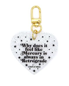 a white heart shaped key chain with a quote on it that says, why does it feel