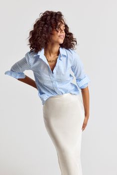 The Icon Shirt runs tailored at the waist, chest and back. For a contemporary fit, order true size. For a blousier fit, size up, or consider The Boyfriend Shirt for an even looser look. Meet your new closet staple: the large check shirt, in our perfect fit cotton stretch. We designed our best-selling Icon Shirt to be fitted throughout, giving you a body-hugging shape yet eliminating blouse gape completely. Our cotton stretch is sourced near and produced in our factory in Portugal by a local team of artisans. Rochelle Behrens reimagined how shirts should fit and feel. Our patented No Gape® button technology, seamlessly designed into every shirt and shirtdress we design, eliminates blouse gape. Finally say bye bye blouse gape, hello The Shirt. 97% Cotton, 3% Stretch Made in Portugal Powered Chic Light Blue Buttoned Blouse, Pale Blue Womens Shirt, Light Blue Relaxed Fit Long Sleeve Blouse, Spring Blue Poplin Shirt, Classic Light Blue Button-up Blouse, Headshot Inspiration, New Closet, Cute Work Outfits, The Boyfriend