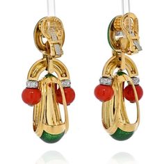 These stunning David Webb 18K Yellow Gold Coral, Green Enamel, and Diamond Door Knocker Earrings are a true testament to the brand's craftsmanship and unique design aesthetic. David Webb is renowned for creating fine jewelry pieces that exude vibrancy, incorporating a delightful blend of colors and materials to make bold statements.These earrings, with their captivating combination of coral beads, green enamel, and yellow gold frames, are a perfect embodiment of David Webb's signature style. The