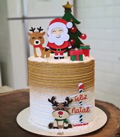 a christmas cake decorated with santa claus and reindeer