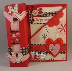 an open red box with hearts inside and two cards in the bottom that say happy valentine's day