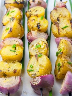 grilled potatoes and onions on skewers with chives