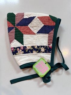 a patchwork purse with a tag attached to it