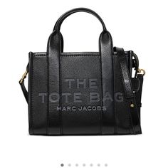 Marc Jacobs Mini Tote Bag Adjustable Removable Crossbody Strap, 21" Drop Double Handles, 4" Drop Dimensions: 10.25"W X 5.5"D X 8"H Top Zip Closure Interior Slip Pocket Signature Embossed Front Gold-Tone Hardware Marc Jacobs Tote, Black Leather Tote Bag, Small Tote Bag, Black Leather Tote, Marc Jacobs Bag, Mini Tote Bag, The Tote Bag, Tote Bag Leather, Black Tote