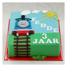 a thomas the train birthday cake with fondant decorations