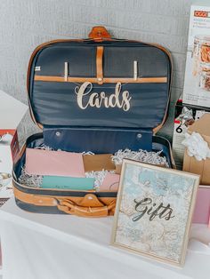 an open suit case sitting on top of a table next to a sign and other items