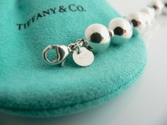 Overview:Offered for sale is a wonderful Tiffany classic. Whether you are just starting your Tiffany collection or are thinking of adding another piece, this one is perfect for you. Tiffany & Co.'s Sterling 19 Ball / Bead bracelet is a Tiffany classic that will never go out of style. The piece makes a statement in its own subtle/simple way. It will most certainly be a piece that you will turn to over and over again, making it great value for your money. It is a wonderful bracelet that fits a Tiffany And Co Jewelry, Tiffany And Co, Gift Pouch, Bracelet Bangle, Tiffany Heart, Heart Charm Bracelet, Bead Bracelet, Go Out, Out Of Style