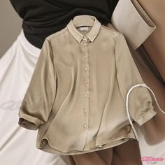 Qteee - Captivating Silk Button-Up Shirt with Single Row Button Closure and Three-Quarter Sleeves Beige Button-up Solid Color Top, Beige Solid Color Button-up Top, Beige Button-up Top With Button Cuffs, Trendy Beige Blouse With Button Closure, Trendy Beige Tops With Button Closure, Trendy Beige Shirt With Buttons, Classic Khaki Tops With Buttons, Trendy Beige Shirt With Button Closure, Casual Khaki Shirt For Office