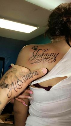 a woman with a tattoo on her arm holding onto another woman's arm and the word mommy written in cursive font