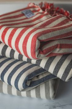 three red, white and blue striped cloths stacked on top of eachother