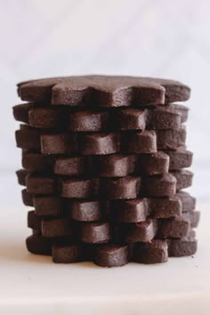 a stack of chocolate cookies sitting on top of a white counter