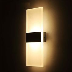 an illuminated wall light in a dark room