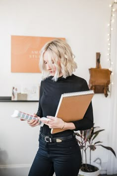 a woman holding a clipboard in her right hand