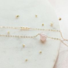 "Classy and delicate. These are the words to describe this dainty Freshwater Pearl and Rose Quartz layered necklace. It is the perfect gift for your bridal party because each Rose Quartz crystal is uniques, just like each of your bridesmaids. Or snag this for yourself! (You deserve it!) Two necklaces in one? You can't beat it! * M A T E R I A L S * 5 small Freshwater Pearls, 1 Rose Quartz Nugget, 14k Gold Fill, 14k Rose Gold Fill, or Sterling Silver chain and findings that are safe on sensitive Pink Delicate Chain Wedding Jewelry, Pink Delicate Chain Jewelry For Weddings, Delicate Crystal Necklace As Gift, Dainty Crystal Necklaces For Gifts, Dainty Crystal Necklace For Gift, Delicate Crystal Necklace With Adjustable Chain, Delicate Crystal Necklace For Gift, Delicate Necklace For Mother's Day, Dainty Charm Necklace For Mother's Day Party