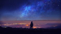 a person standing on top of a hill looking at the stars