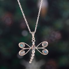 With a short lifespan and many challenges to overcome, dragonflies have practiced a lifestyle of change and transformation, which allows them to enjoy their existence to the fullest. This wise lesson of nature is what inspires Sapna Mehta to design this sterling silver necklace crafted in India. The dragonfly pendant that dangles at the bottom is polished, enriching the labradorite jewels set on each wing. Wood Dangle Earrings, Sterling Silver Cat, Dragonfly Pendant, Beaded Pendant Necklace, Necklace Craft, Tourmaline Beads, Labradorite Pendant, Dragonflies, Jewelry Packaging