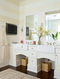 a large bathroom with two sinks and mirrors