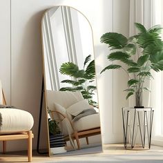 a mirror sitting on top of a wooden floor next to a chair and potted plant