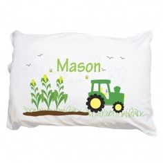 a pillow with a tractor on it and the words mason written in large letters above