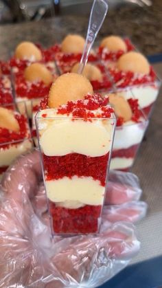 red velvet desserts with white frosting and sprinkles are on display