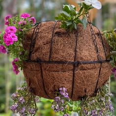 a hanging planter filled with purple flowers