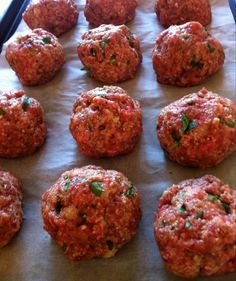 raw meatballs on a baking sheet ready to go into the oven or grilling