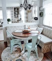 a dining room table with two chairs and a bench in front of the kitchen door