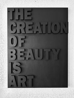 the creation of beauty is art in black and white, with text overlaying it